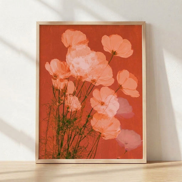 Soft watercolor cosmos flower in coral and peach tones with sage green leaves, framed as a modern botanical poster on a wall.