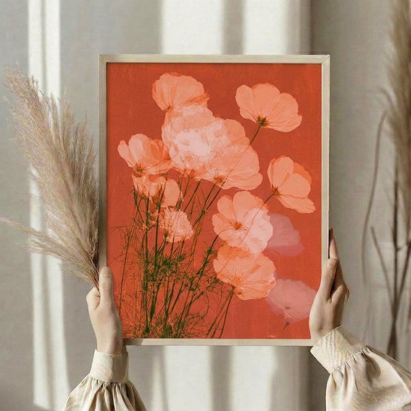Romantic watercolor painting of a cosmos bloom in warm terracotta and peachy hues with delicate green foliage, displayed as a framed art print.