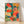 Whimsical retro boho poster featuring a seahorse surrounded by vibrant coral, seaweed, and marine plants in warm coral red, teal, golden yellow, and seafoam green tones; framed wall art with a tropical, calming ocean garden aesthetic.