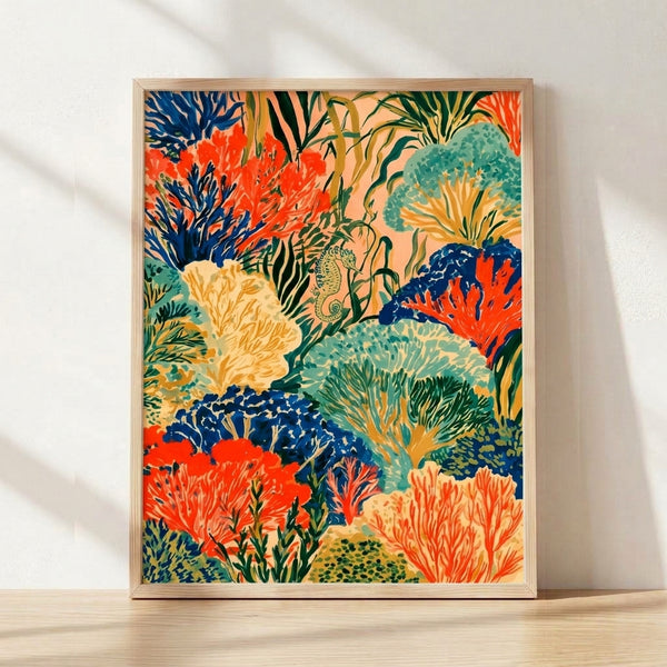 Vibrant coral reef art print featuring an ornate seahorse surrounded by swaying seaweed, anemones, and tropical plants in rich coral red, navy, and seafoam green tones with golden accents, framed on a wall.
