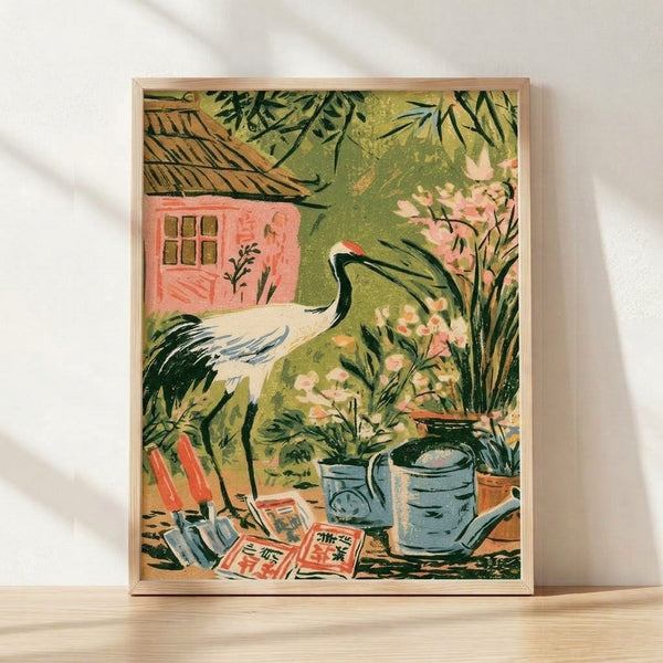 Framed cottagecore poster featuring a red-crowned crane standing in a lush garden beside a cottage, surrounded by blooming flowers, potted plants, and a terracotta watering can in soft sage green, coral pink, and cream tones.