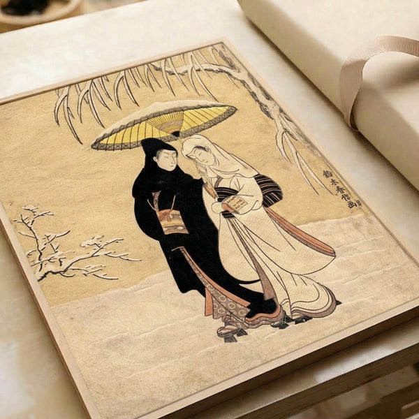 Framed ukiyo-e print depicting a couple under an umbrella during snow with willow tree elements, executed in the classic Japanese woodblock style with cream and pale blue palette.