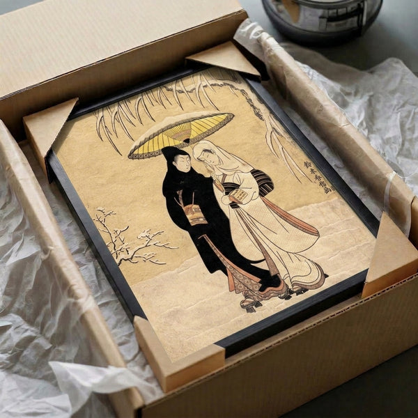 Romantic Japanese art print of two figures beneath an umbrella in falling snow with willow branches, showcasing traditional woodblock artistry in cream, black, and gold.