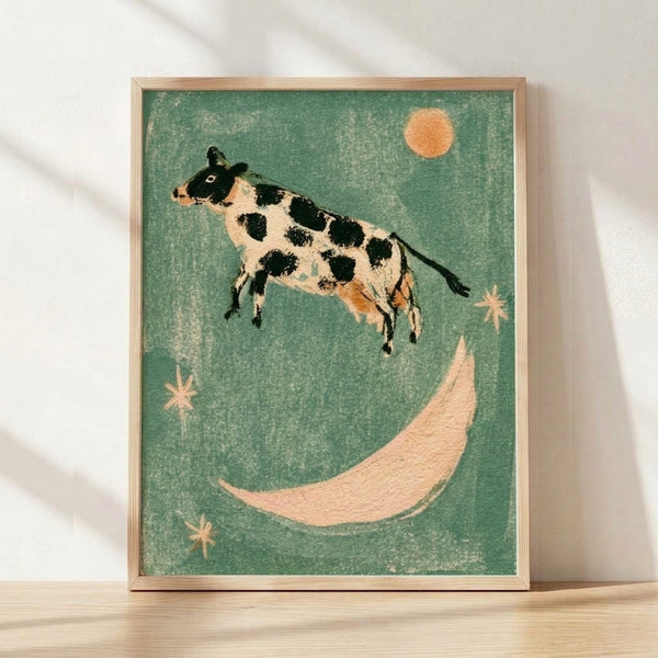 Whimsical folk art poster featuring a cow leaping over a crescent moon with stars, rendered in sage green, cream, black, and apricot tones with a dreamy, nostalgic cottagecore aesthetic.