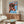 Framed wall art print with simplified cow head rendered in saturated orange on blue background, dynamic pop art style.