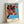 Contemporary pop art wall print of a cow head rendered in saturated orange, blue, and neon yellow-green tones with playful, ironic aesthetic.