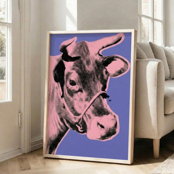 Bold pop art interpretation of a cow in vibrant pink hues on a striking purple ground, presented as a framed modern art print.