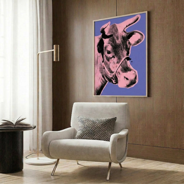 Framed pop art poster showcasing a cow head in luminous pink pigment set against a saturated purple canvas for dynamic wall decor.
