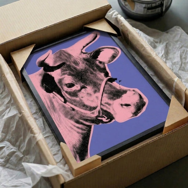 Vibrant pop art cow portrait in hot pink and deep purple tones, displayed as a framed art print that brings modern energy to any room.