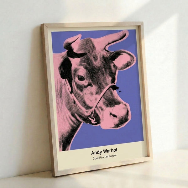 Vibrant pop art wall art with a cow head rendered in hot pink and white on a deep purple ground, capturing the bold spirit of modern pop imagery.