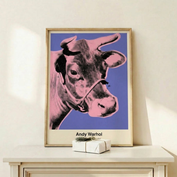 Contemporary pop art poster showing a playful cow face in contrasting pink and black strokes against a purple backdrop.