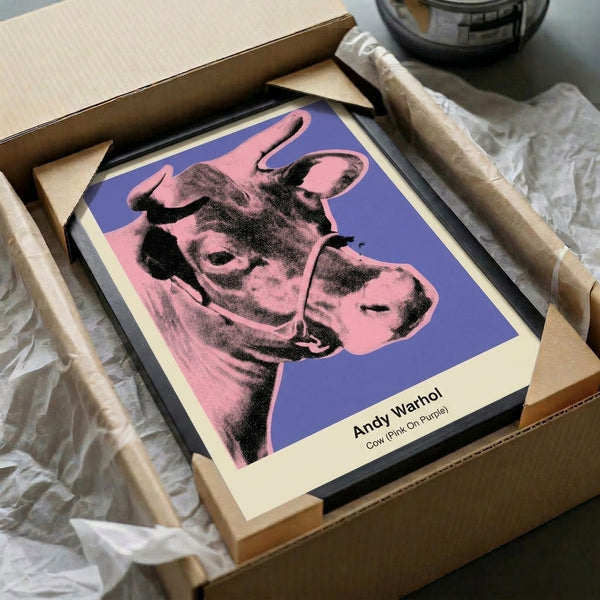 Colorful pop art wall poster depicting a cow head in bright pink tones set against vibrant purple, embodying playful modern art sensibility.