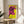 Kitsch-inspired framed print with a striking pink bovine head design floating on a cheerful yellow field.