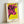 Pop art cow head rendered in hot pink with black contours on a sunny yellow background, mounted as a contemporary wall poster.
