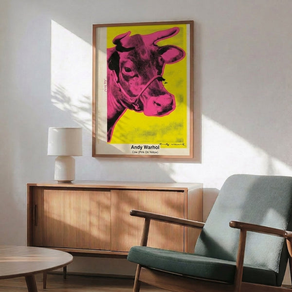 Contemporary pop art wall print showing a cow head in hot pink against golden yellow background, executed in bold graphic style.