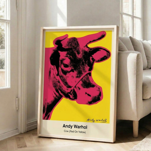 Playful pop art print of a cow head rendered in bright red and yellow against white, capturing the subversive spirit of modern pop art.
