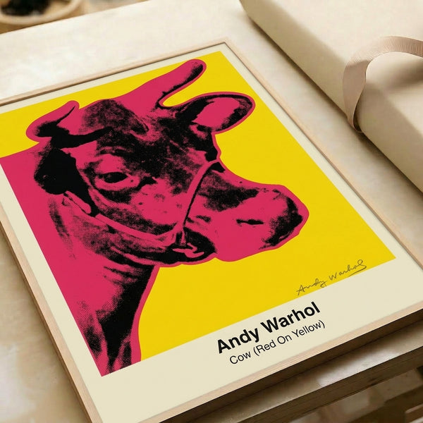 Red and yellow pop art cow portrait with black graphic linework, a modern Bauhaus-influenced poster perfect for adding vibrant artistic flair to any room.