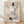 Abstract minimalist poster featuring a bleached cow skull centered with delicate calico roses in cream, tan, and gray tones against a soft white background.