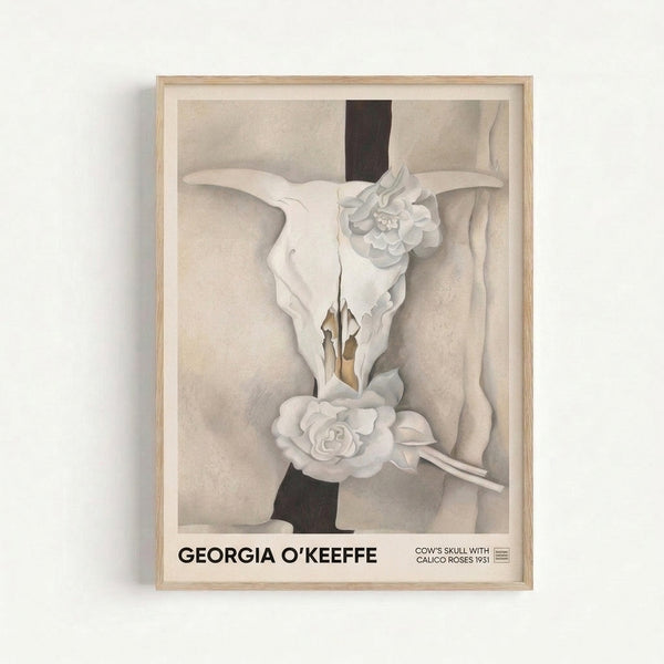 Framed art print displaying an ethereal composition of a bone skull adorned with pale pink and cream flowers in a contemplative, sensual style.