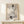Abstract floral and skull composition in cream and gray hues, featuring intricate rose details in a serene, wabi-sabi aesthetic framed on a wall.