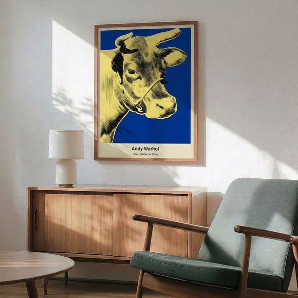 Warhol-style pop art print of a cow head in yellow and magenta on vibrant blue, delivering irreverent color-field abstraction with high-impact visual punch.