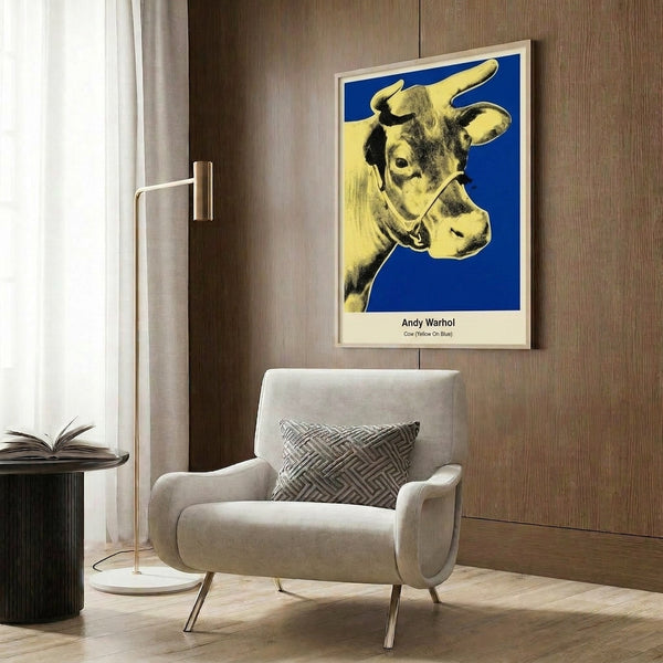 Modern pop art wall poster depicting a stylized cow in yellow and hot pink tones against striking blue, embodying the bold graphic sensibility of contemporary pop movements.