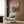 Modern wall art capturing the charm of a brick bookstore with sage and cream accents, soft natural light, and inspirational cozy reading room vibes in retro style.