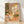 Minimalist Japandi-style poster depicting a serene kitchen corner with a coffee maker, potted plants, and bookshelf bathed in soft window light, rendered in warm beige, terracotta, and forest green tones.