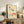 Framed Japanese wall art depicting a poised crane in flight against a glowing red sun, combining serene aesthetics with Japandi design sensibility.
