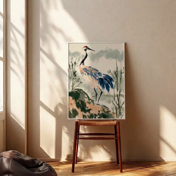 Peaceful framed watercolor artwork depicting a crane amid reeds and rocky terrain in a fog-shrouded wetland, executed in the Japanese aesthetic with dusty blues and warm coral highlights.
