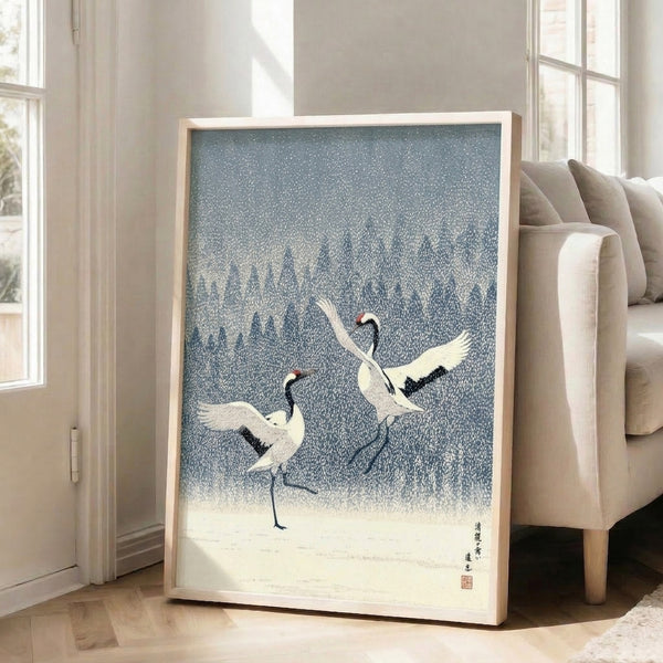 Zen-inspired poster of dancing cranes amid falling snow and bare trees, minimalist composition in indigo, cream, and subtle red accents creating calm atmosphere.