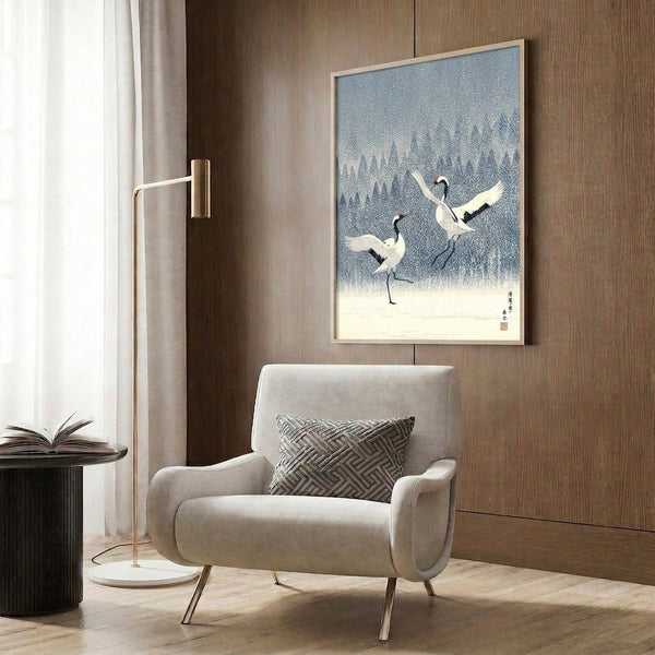 Wall-mounted art print featuring graceful cranes in a snowy forest landscape, minimalist Japanese style in cool slate blue and white tones with red accent highlights.