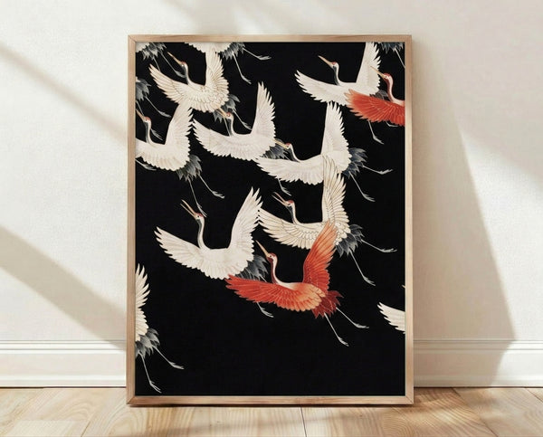 Framed Japanese woodblock-style art print depicting graceful cranes in flight with elegant black linework on cream background, accented with coral red and charcoal grey.