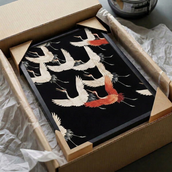 Framed Japanese crane poster displaying birds in elegant flight composition, executed in traditional woodblock style with black linework and cream, red, and grey palette.