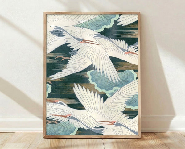 Serene Japanese woodblock-style poster of flying cranes in cream, forest green, and slate blue tones with gold accents, framed on a wall.