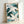 Meditative Japandi wall art depicting cranes with delicate leaves in muted forest green, slate blue, and cream, gold highlights throughout.