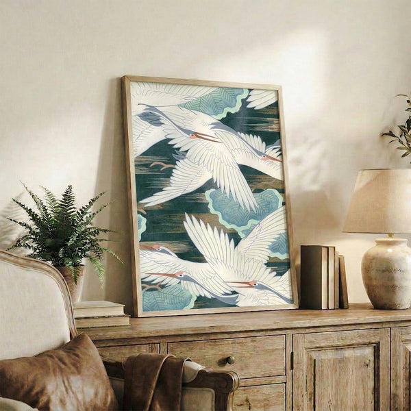 Japandi-style framed poster of soaring cranes with botanical elements in harmonious cream, forest green, slate blue, and coral palette.