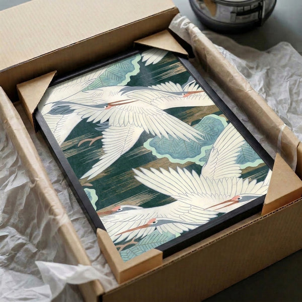 Serene woodblock wall art featuring graceful cranes in flight with leaves and water, rendered in soft cream, blue-green, and gold tones.