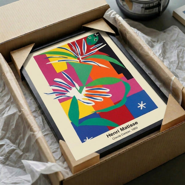 Vibrant framed artwork depicting a stylized dancer through abstract geometric cut-outs in saturated reds, blues, and warm ochre, celebrating joyful motion and modern artistic vision.