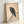 Zen-inspired bird art print showing a crow on a rocky surface in naturalistic black ink on cream paper, framed and displayed as wall decor.