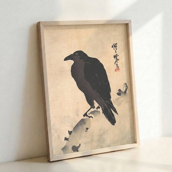 Zen-inspired bird art print showing a crow on a rocky surface in naturalistic black ink on cream paper, framed and displayed as wall decor.