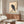 Framed black and cream Japanese art print of a crow seated on a rock, rendered in minimalist ink style with serene naturalistic details.