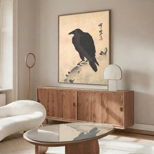 Framed black and cream Japanese art print of a crow seated on a rock, rendered in minimalist ink style with serene naturalistic details.
