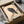 Contemplative Asian wall art showcasing a solitary crow on stone in charcoal and black ink against a cream ground, minimalist woodblock-inspired design.
