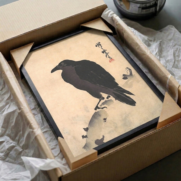 Contemplative Asian wall art showcasing a solitary crow on stone in charcoal and black ink against a cream ground, minimalist woodblock-inspired design.