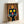 Whimsical pop art poster showing a black cat sporting a decorative crown against a colorful background of warm and cool tones.
