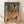 Abstract cubist portrait in ochre, tan, and dark green tones, featuring a fractured male figure rendered in geometric planes and analytical style.