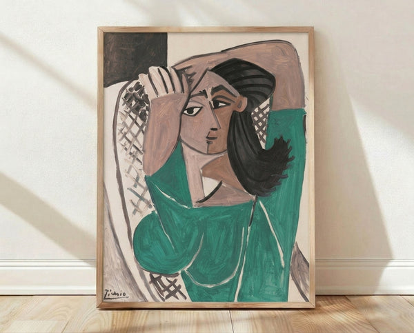 Abstract cubist portrait of a woman in emerald green and tan tones with bold black line work, framed poster art on a wall.