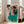 Black linear cubist portrait of a woman rendered in emerald green and cream, minimalist geometric art on a gallery wall.
