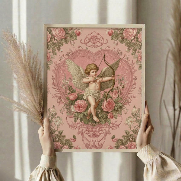 Romantic wall art print in vintage style depicting a cherub with roses and ornamental heart, painted in soft dusty rose and sage green with cream accents.